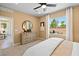 Bright bedroom with a large dresser, ceiling fan, and window view, offering a comfortable and inviting space at 4180 E Brusca Way, Pahrump, NV 89061