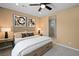 Relaxing bedroom with a ceiling fan, neutral color scheme, and a glimpse into the en-suite bathroom at 4180 E Brusca Way, Pahrump, NV 89061