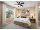 Serene bedroom with a large window, ceiling fan, and decorative wall art above the bed at 4180 E Brusca Way, Pahrump, NV 89061
