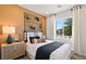 Cozy bedroom with modern furnishings, decorative wall art, and a bright window view at 4180 E Brusca Way, Pahrump, NV 89061