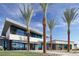 Striking modern home design with towering palm trees and a well-manicured lawn at 4180 E Brusca Way, Pahrump, NV 89061