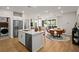Open-concept kitchen with stainless steel appliances, a center island, and dining area at 4180 E Brusca Way, Pahrump, NV 89061
