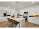 Open kitchen boasts a center island with bar stool seating, stainless steel appliances, and stylish decor at 4180 E Brusca Way, Pahrump, NV 89061