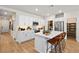 Bright kitchen features stainless steel appliances, white cabinets, and a center island with bar stool seating at 4180 E Brusca Way, Pahrump, NV 89061