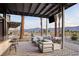 Outdoor patio area with comfortable seating, a television, and views of the mountains at 4180 E Brusca Way, Pahrump, NV 89061