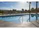 Inviting pool with lounge chairs overlooking lush greenery and mature trees at 4180 E Brusca Way, Pahrump, NV 89061