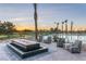 Outdoor pool area with fountain, lounge chairs, and palm trees against a scenic sunset at 4180 E Brusca Way, Pahrump, NV 89061