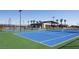 Outdoor blue tennis courts with a community center and landscaping nearby at 4180 E Brusca Way, Pahrump, NV 89061