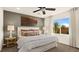 Relaxing bedroom features a large window, a comfortable bed and soft lighting at 4200 E Brusca Way, Pahrump, NV 89061