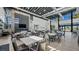 Large dining area featuring tables and chairs, a modern fireplace, and plenty of natural light from the large windows at 4200 E Brusca Way, Pahrump, NV 89061