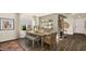 A well-lit dining area featuring hardwood floors, modern decor, and a cozy atmosphere, perfect for entertaining at 4200 E Brusca Way, Pahrump, NV 89061