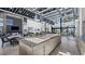 Open community kitchen with island, bar seating, granite countertops, stainless appliances, and tables for dining at 4200 E Brusca Way, Pahrump, NV 89061
