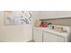 Bright laundry room features modern white appliances and playful cat-themed decor at 4200 E Brusca Way, Pahrump, NV 89061