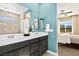 Bright bathroom with a double sink vanity and adjacent bedroom featuring a window at 4250 E Brusca Way, Pahrump, NV 89061