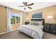 Comfortable bedroom featuring neutral paint, ceiling fan, and large window for natural light at 4250 E Brusca Way, Pahrump, NV 89061