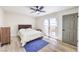 Bedroom featuring a queen bed, ceiling fan, and doors leading to the exterior at 4437 Alto Verde Dr, Las Vegas, NV 89119