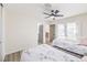 Bedroom featuring two beds, fan, doors leading to the exterior, and light colored walls at 4437 Alto Verde Dr, Las Vegas, NV 89119