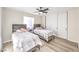 Bright bedroom with two beds, ceiling fan, and closet with sliding doors at 4437 Alto Verde Dr, Las Vegas, NV 89119