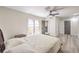 Bedroom featuring a queen bed, ceiling fan, and doors leading to the exterior at 4437 Alto Verde Dr, Las Vegas, NV 89119