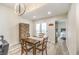 Cozy dining area with modern lighting, wood table, and a view into the bedroom at 4437 Alto Verde Dr, Las Vegas, NV 89119