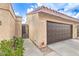 Home featuring a two-car garage, gated entry, and desert landscaping at 4437 Alto Verde Dr, Las Vegas, NV 89119
