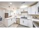 Bright kitchen with modern appliances, white cabinets, and a convenient breakfast bar area at 4437 Alto Verde Dr, Las Vegas, NV 89119