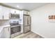 Modern kitchen features stainless steel appliances, white cabinets, and hardwood floors at 4437 Alto Verde Dr, Las Vegas, NV 89119