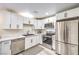 Modern kitchen featuring stainless steel appliances, white cabinets, and sleek countertops at 4437 Alto Verde Dr, Las Vegas, NV 89119