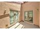 Enclosed patio featuring stucco walls and glass doors, offering a private outdoor space at 4437 Alto Verde Dr, Las Vegas, NV 89119