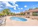 Community pool with lounge chairs and tables for relaxation, set against a backdrop of lush landscaping at 4437 Alto Verde Dr, Las Vegas, NV 89119