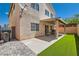 Spacious backyard featuring a covered patio, artificial grass, and ample room for outdoor activities and relaxation at 4507 Grotto Ct, North Las Vegas, NV 89031