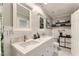 Updated bathroom features double sink vanity, marble floors, and modern fixtures at 4507 Grotto Ct, North Las Vegas, NV 89031