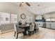 Bright dining area with a table and chairs, adjacent to a modern kitchen and living space at 4507 Grotto Ct, North Las Vegas, NV 89031