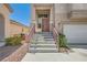 Welcoming entrance featuring stone steps with railings, front door and desert landscaping at 4507 Grotto Ct, North Las Vegas, NV 89031