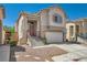 Inviting exterior showcases a two-story home, desert landscaping, and two car garage at 4507 Grotto Ct, North Las Vegas, NV 89031