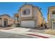 Two-story home with a well-maintained exterior, featuring a two car garage and landscaping at 4507 Grotto Ct, North Las Vegas, NV 89031