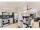 Open-concept kitchen featuring stainless steel appliances, dark backsplash, and spacious dining area at 4507 Grotto Ct, North Las Vegas, NV 89031