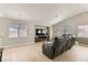 Comfortable living room with a large sofa, hardwood floors, and abundant natural light at 4507 Grotto Ct, North Las Vegas, NV 89031