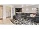 Comfortable living room with a sectional sofa, black and white rug, and a stylish bar area for entertaining at 4507 Grotto Ct, North Las Vegas, NV 89031