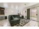Open-concept living room features comfortable seating and a sliding glass door to the backyard at 4507 Grotto Ct, North Las Vegas, NV 89031
