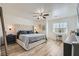 This main bedroom features a large upholstered headboard, light wood floors, and vanity area at 4507 Grotto Ct, North Las Vegas, NV 89031