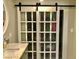 Stylish bathroom vanity with white countertops and sliding barn door closet at 502 E Fairway Rd, Henderson, NV 89015
