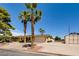 Charming single-story home featuring a spacious driveway, two palm trees, and a two-car garage at 502 E Fairway Rd, Henderson, NV 89015