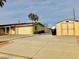 A ranch-style home featuring a long driveway, garage, and additional storage shed at 502 E Fairway Rd, Henderson, NV 89015