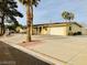 A ranch-style home featuring a long driveway, garage, and desert landscaping at 502 E Fairway Rd, Henderson, NV 89015