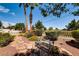 A peaceful garden featuring stone pathways, lush plants, and a charming bench at 502 E Fairway Rd, Henderson, NV 89015