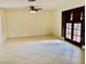 Spacious living room with bright tile floors and access to the outdoor space through French doors at 502 E Fairway Rd, Henderson, NV 89015