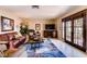 Cozy living room with a flatscreen television, nice furniture, and elegant French doors at 502 E Fairway Rd, Henderson, NV 89015