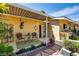 Cozy outdoor patio with bistro seating, lush plants, and stucco walls at 502 E Fairway Rd, Henderson, NV 89015