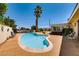 Inviting backyard pool area featuring a kidney-shaped pool, lounge chairs, and lush landscaping at 502 E Fairway Rd, Henderson, NV 89015